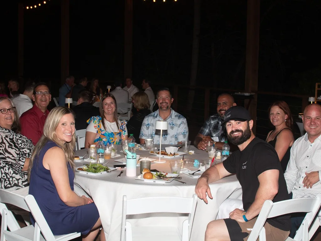 Another group of Forum attendees seated together at dinner
