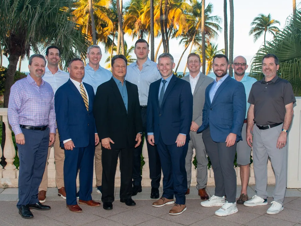 Forum attendees gathered for an outdoor group portrait at night