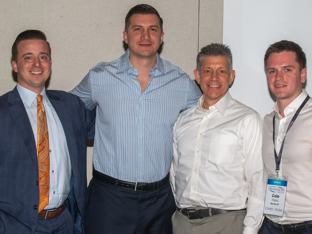 Four Forum attendees posing together indoors
