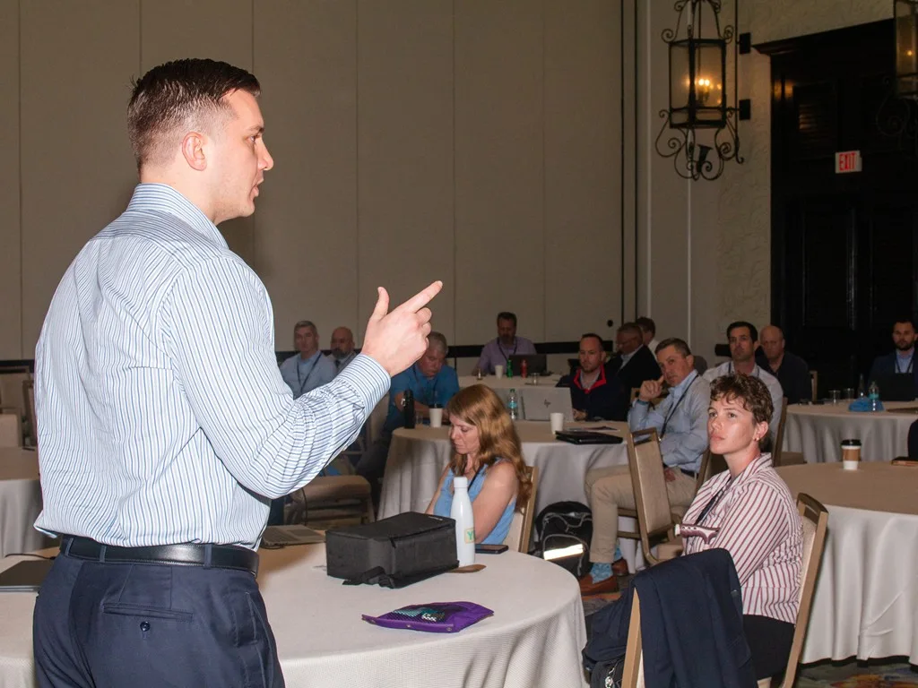 Presenter addressing seated advisors at the Forum