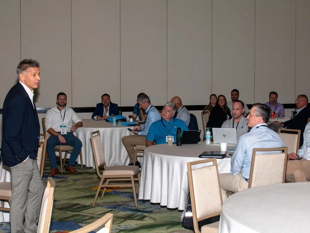 Speaker facing a seated group of Forum attendees